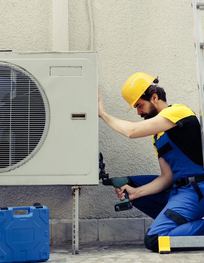 Repairman working on air conditioner